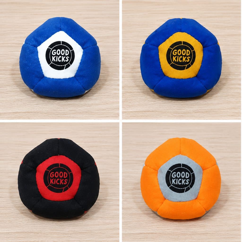 Six Good Kicks foot bag colorways on a wood table